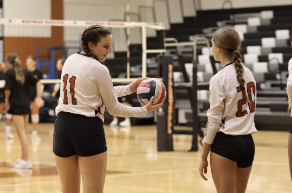 Anticipating their first game of the season, Setter Henley Hammonds '28 and Pin Hitter Aurora Simmons '28 warm up during the pre-game prep time. Both players contributed to the offensive efforts Westwood put forth during the game. 